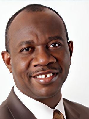 A smiling man in a suit looking at the camera.