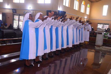 A choir of nuns singing in a church.