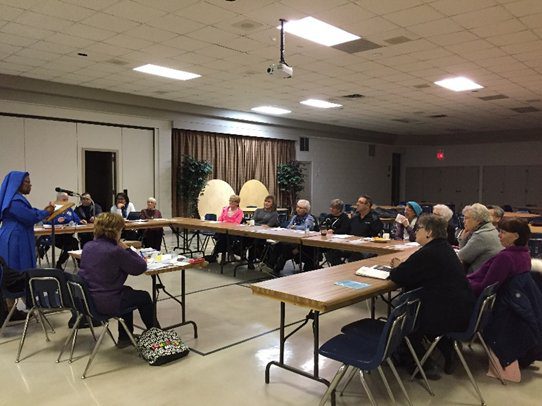 Community members gathered in a meeting room for a discussion.