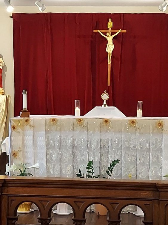 Ornate altar with a crucifix and candles in a church.